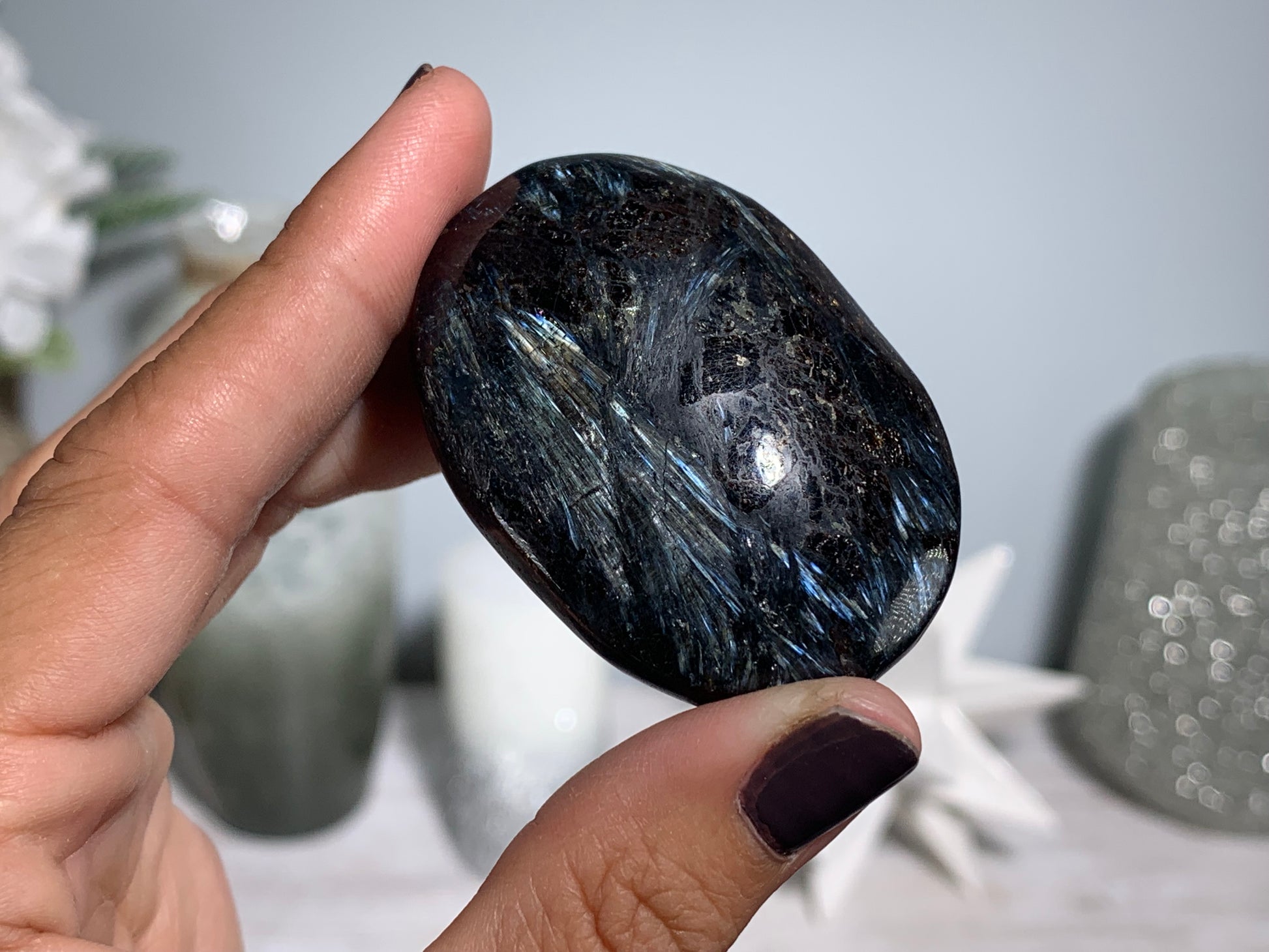 Anthophyllite in Eudialyte with Pyrite Palm Stone Crystal against a white gray floral background