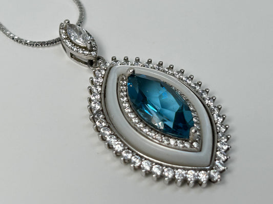 Blue Topaz Eye Pendant with Cubic Zirconia in Sterling Silver for natural grounding on table with white background