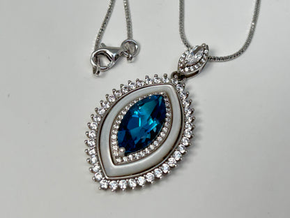 Silver necklace with a Blue Topaz Eye Pendant with Cubic Zirconia in Sterling Silver on a light gray background