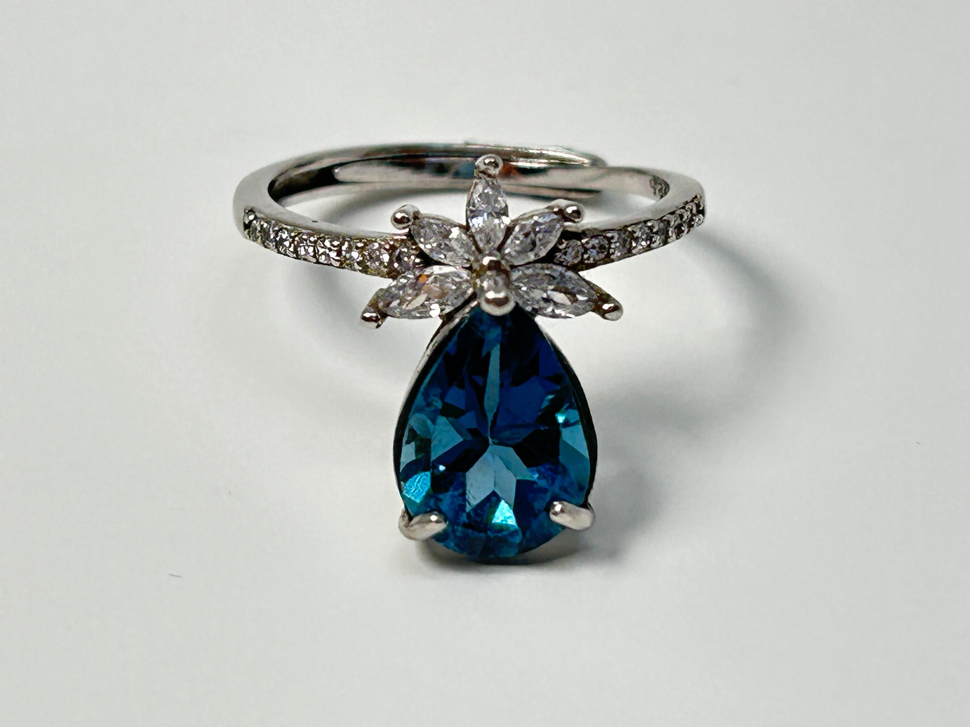 Blue Topaz Ring with Cubic Zirconia in Sterling Silver for natural grounding on table with white background 