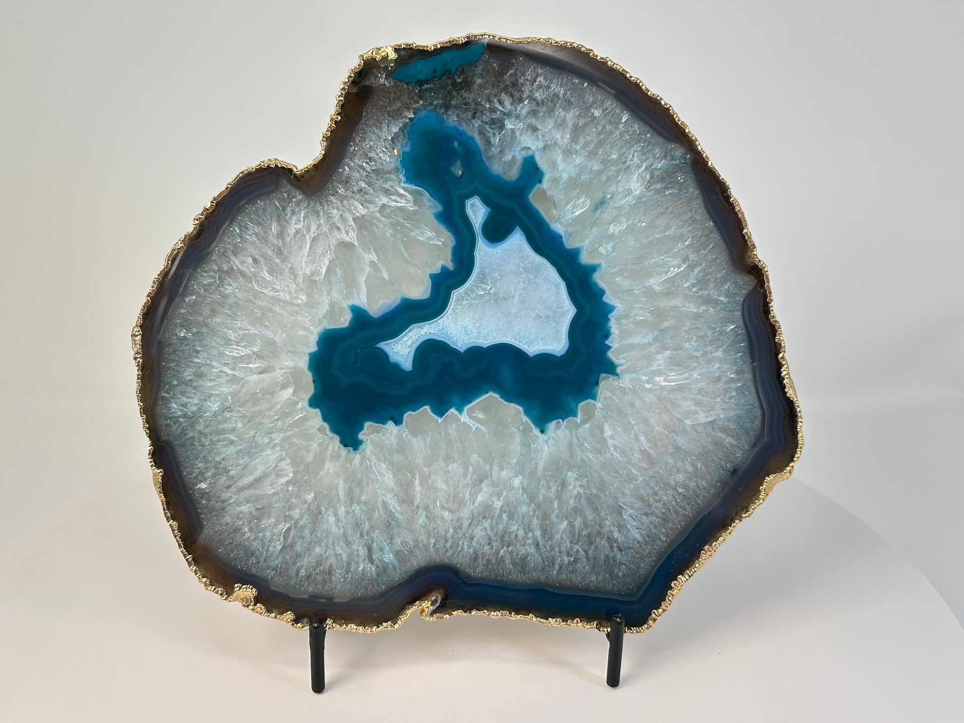 Calming and harmonizing Dyed Blue Agate Plate for natural grounding on table with white background