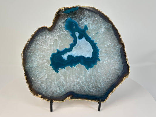 Calming and harmonizing Dyed Blue Agate Plate for natural grounding on table with white background