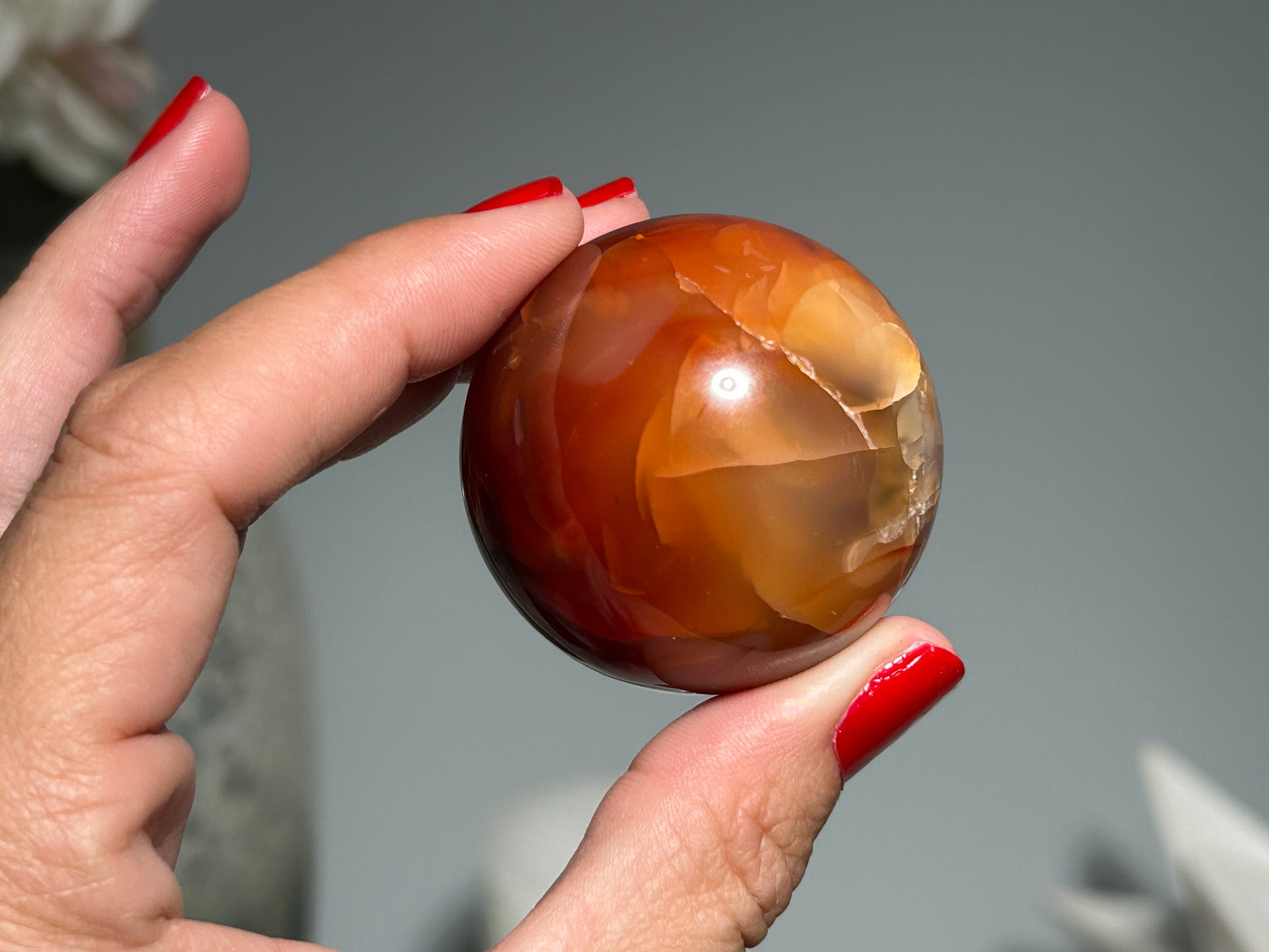 Polished Carnelian gemstone sphere meditation crystal promoting vitality courage and confidence