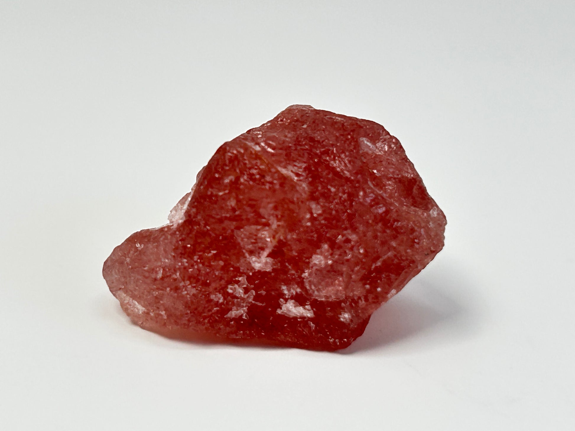 Natural Cherry Tanzurine Quartz for energy healing on table with white background.