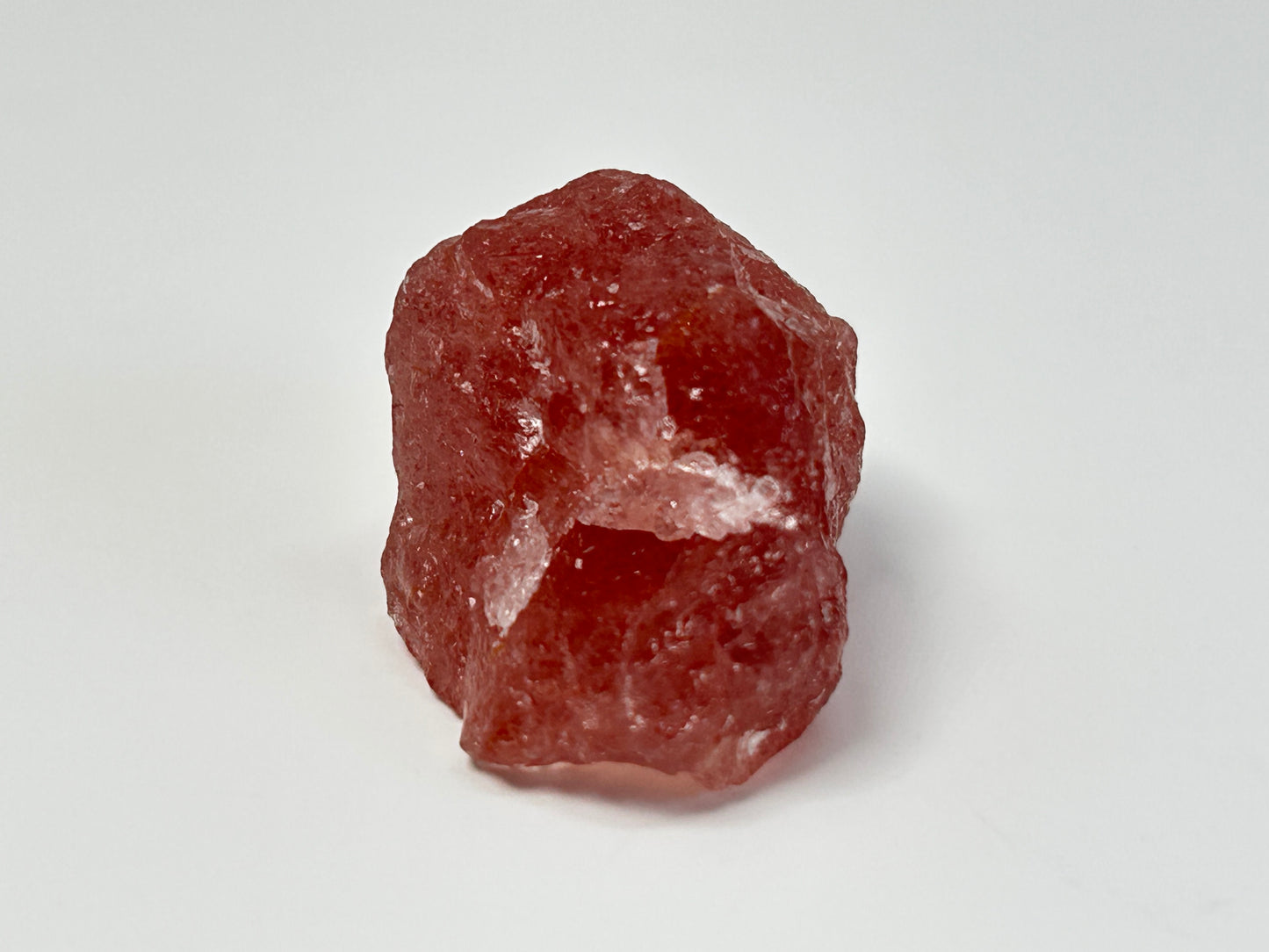 Natural Cherry Tanzurine Quartz for natural grounding on table with white background.