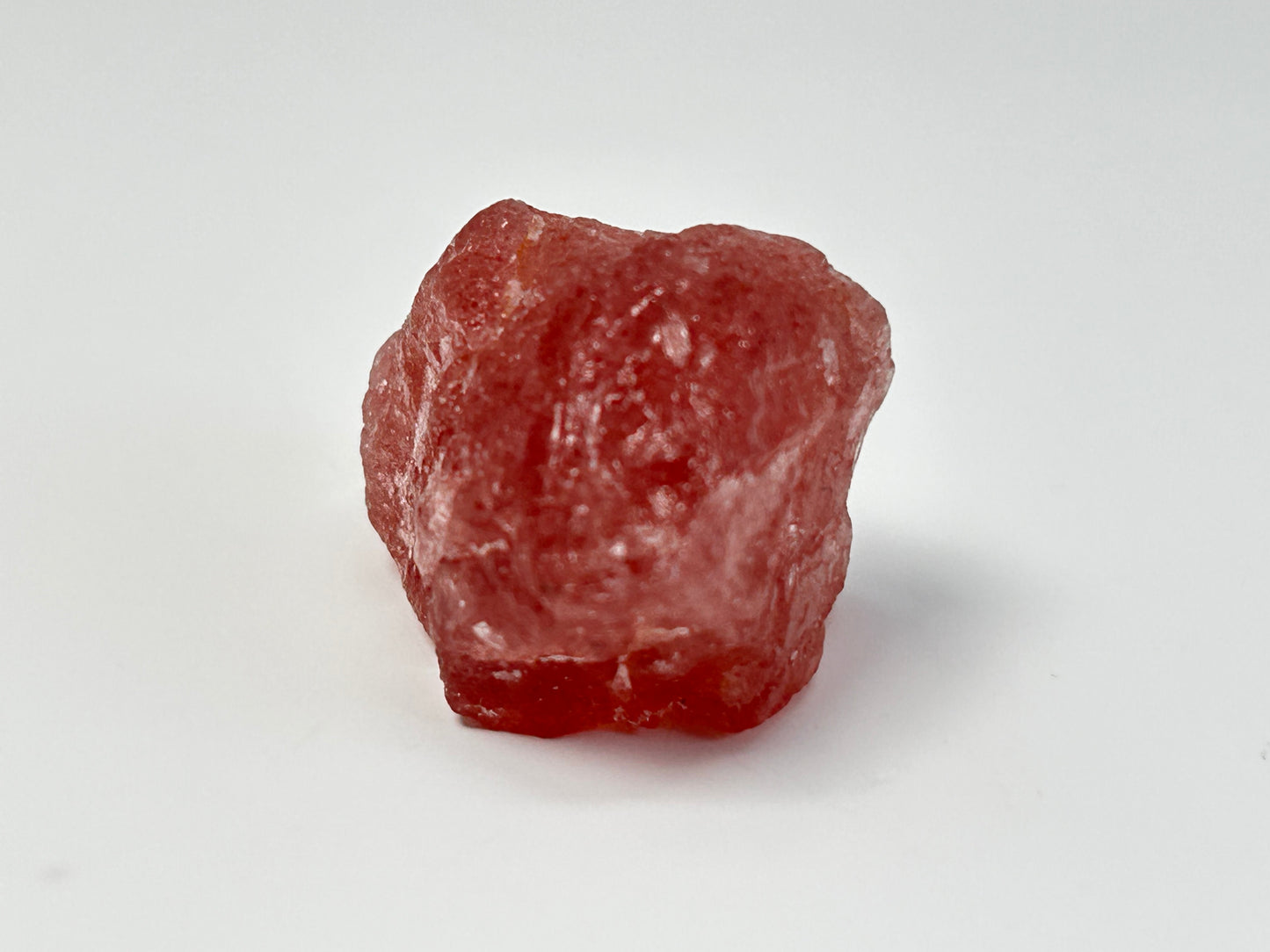Natural Cherry Tanzurine Quartz on table top with white background