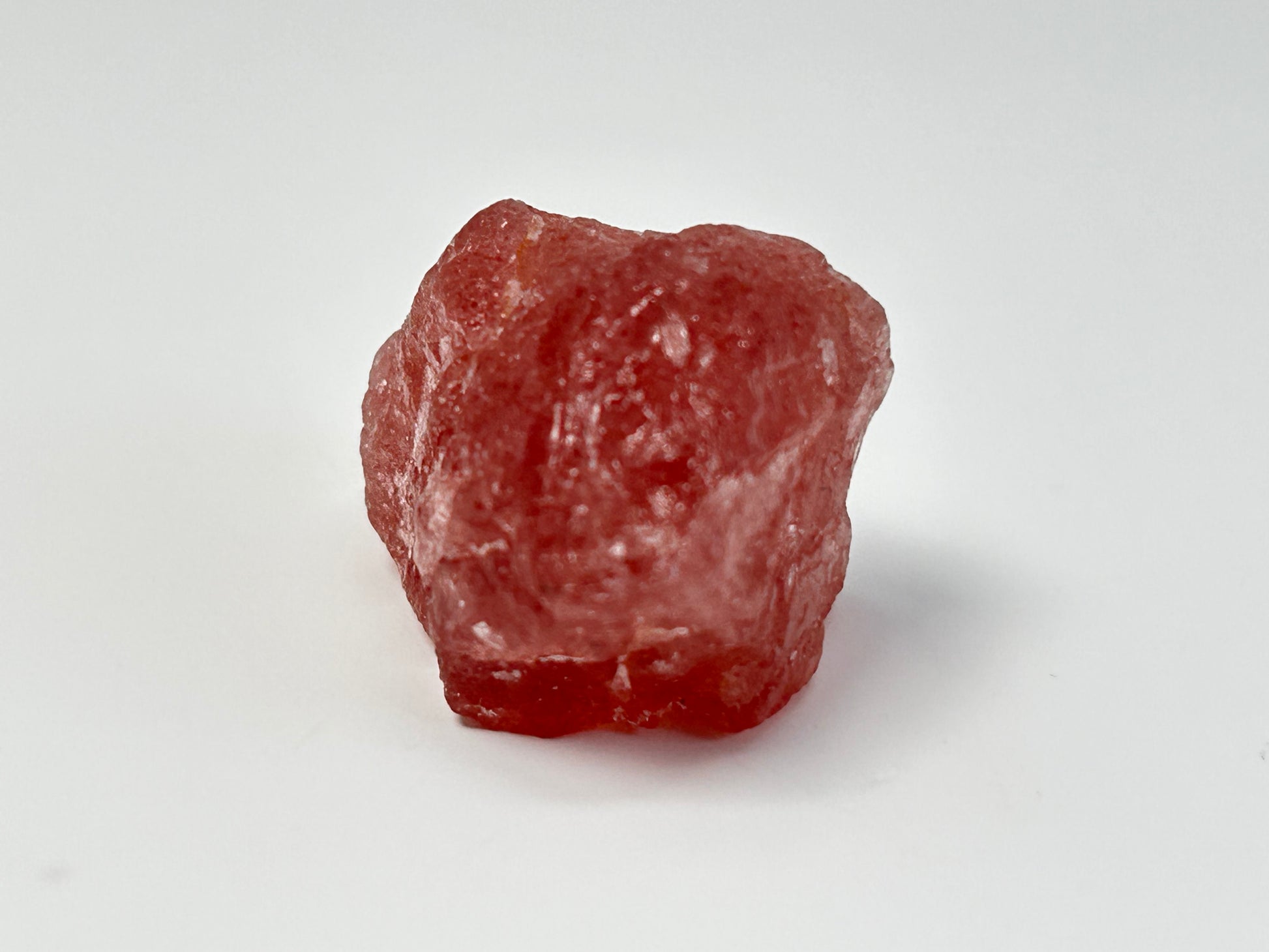 Natural Cherry Tanzurine Quartz on table top with white background