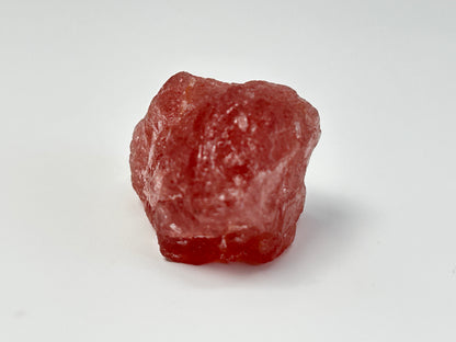 Natural Cherry Tanzurine Quartz on table top with white background