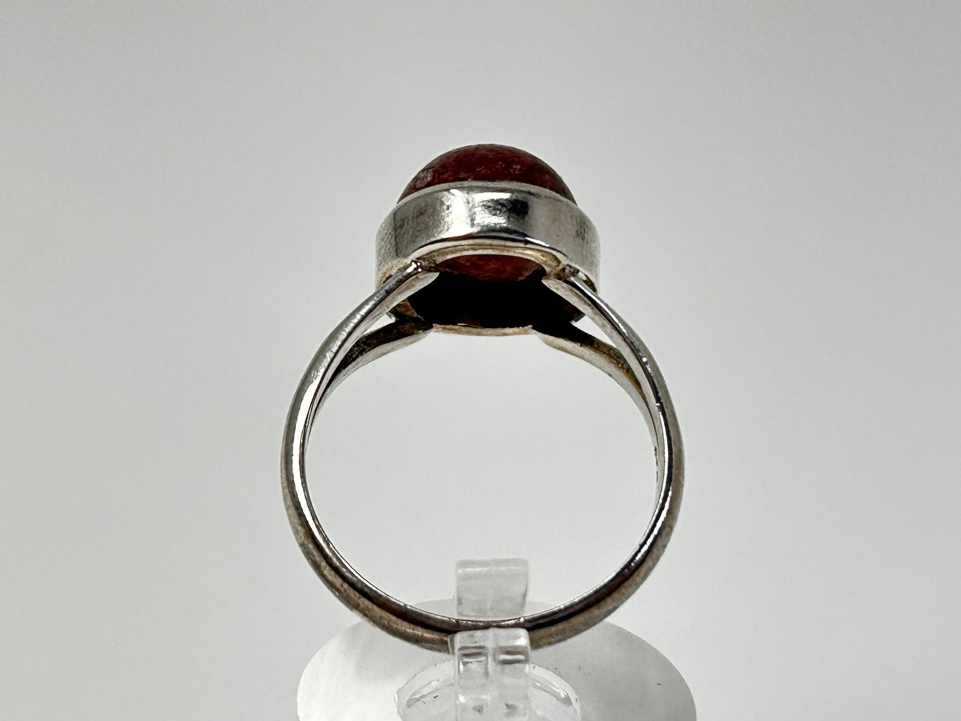 Cherry Tanzurine Sterling Silver Ring for natural grounding on table with white background. 