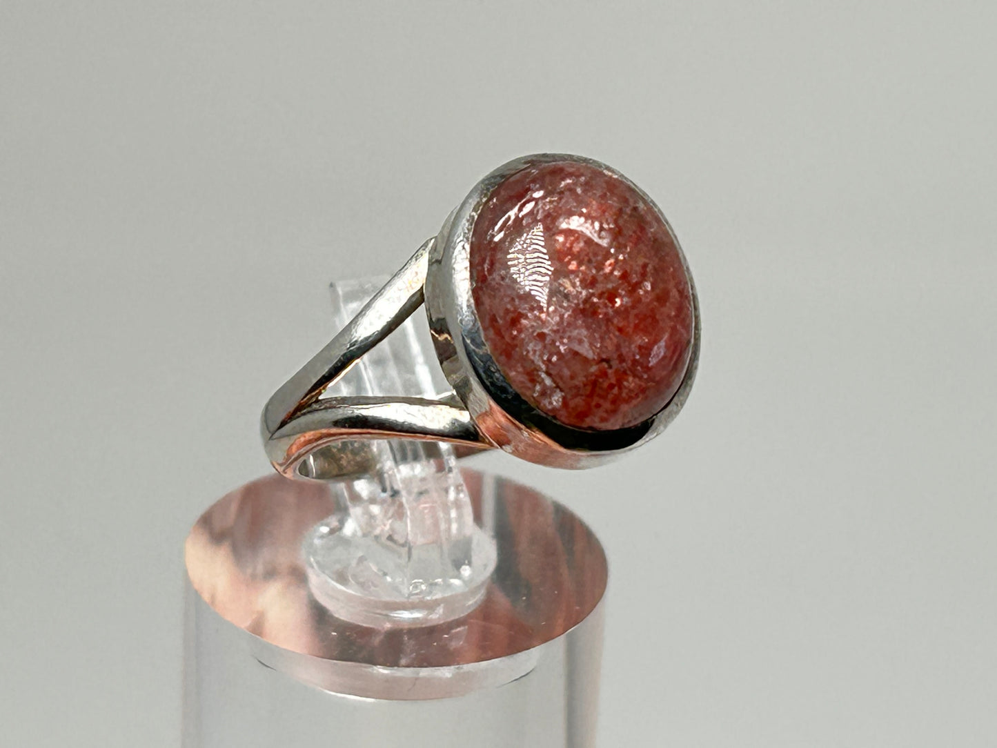 Cherry Tanzurine Sterling Silver Ring for energy healing in ring display on table with white background. 