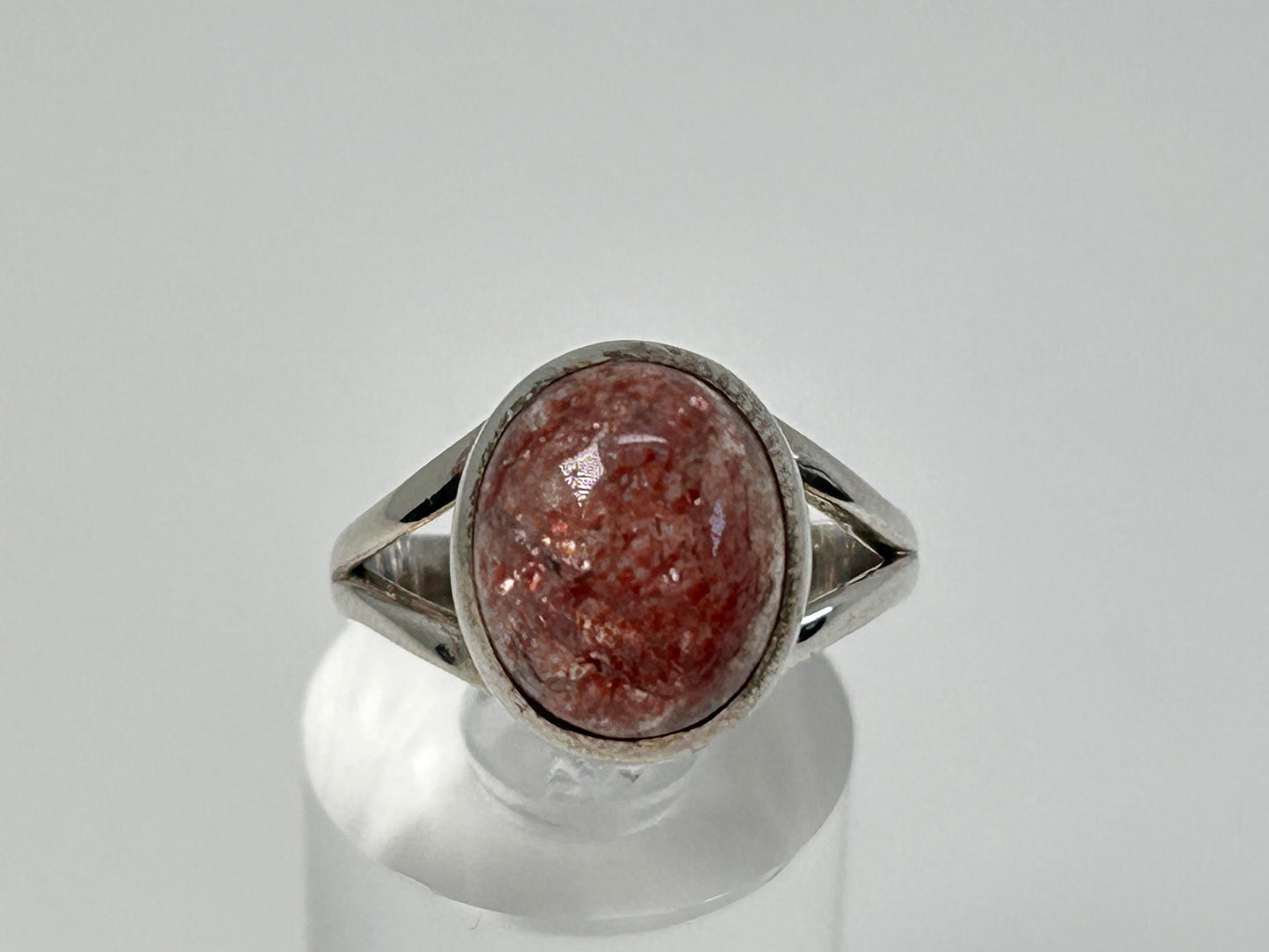 Cherry Tanzurine Sterling Silver Ring for energy healing on table with white background.