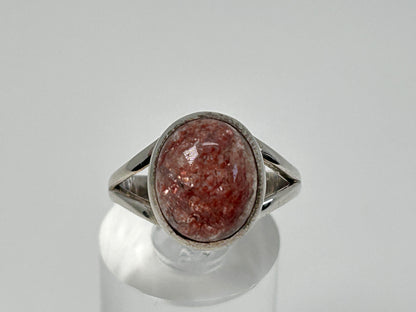 Cherry Tanzurine Sterling Silver Ring for energy healing on table with white background.