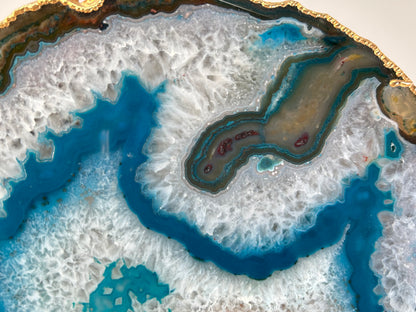 Close-up of Dyed Blue Agate Plate geode with blue and brown mineral deposits