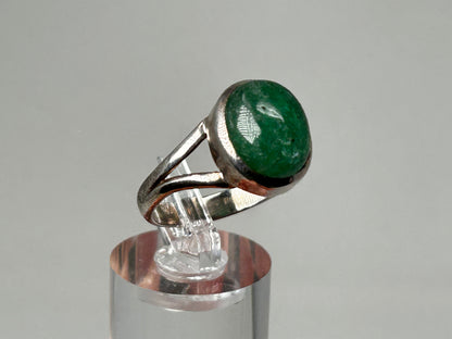 Emerald Tanzurine Sterling Silver Ring for energy healing on table with white background.