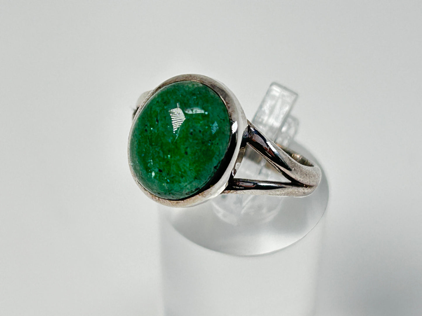 Emerald Tanzurine Sterling Silver Ring on table top with white background