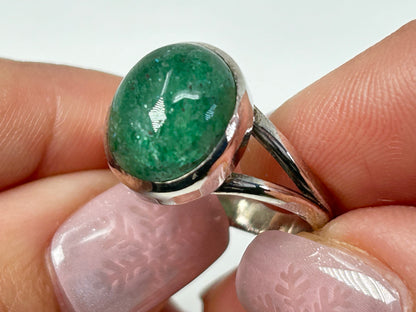 Hands holding Emerald Tanzurine Sterling Silver Ring with white background.
