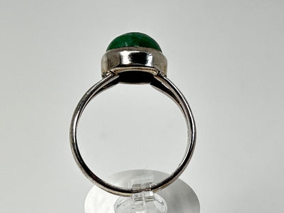 Emerald Tanzurine Sterling Silver Ring on table top with white background