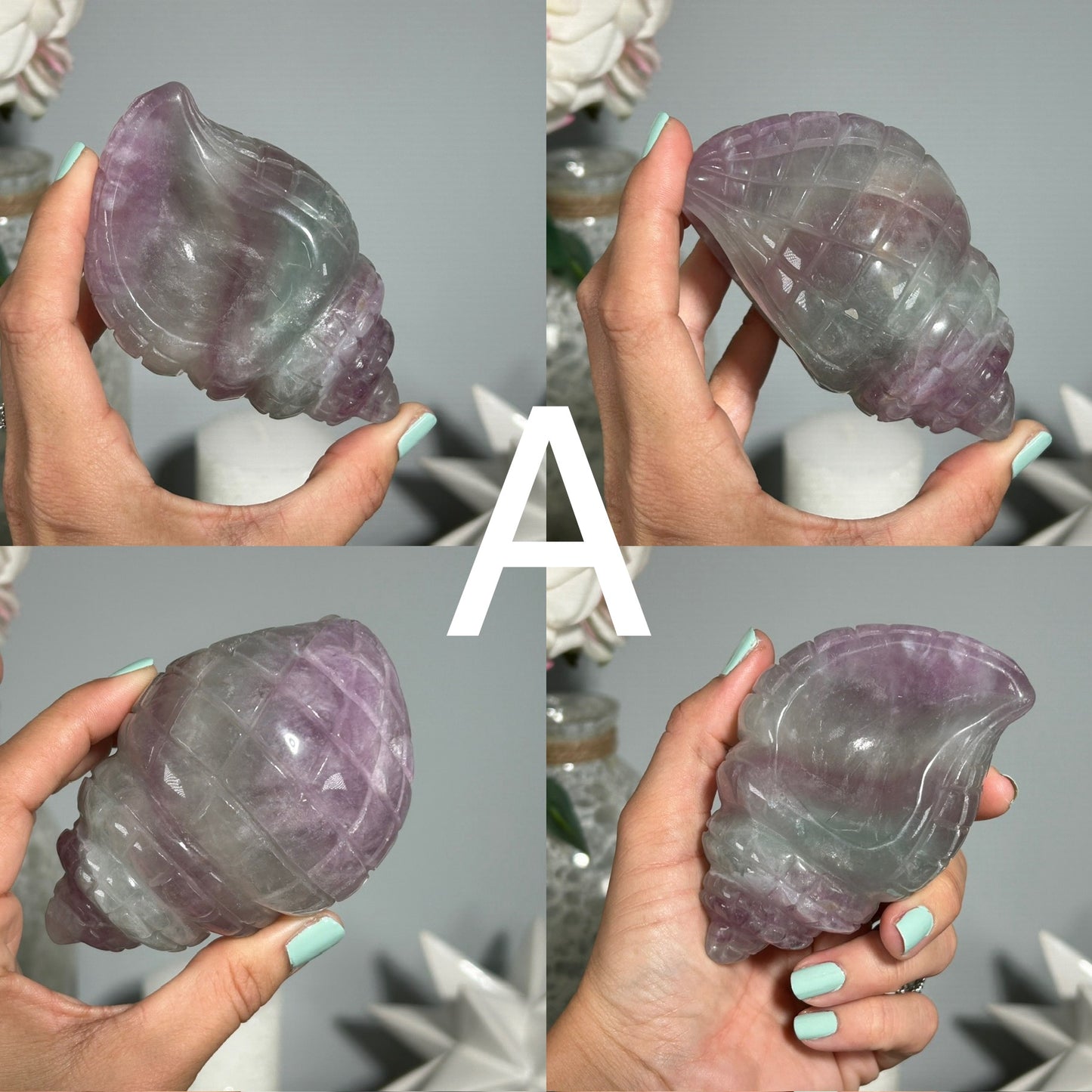 Hands holding a Fluorite gemstone with colorful healing crystals in background