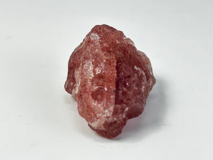 Natural Cherry Quartz Tanzurine Chunk for natural grounding on table with white background.