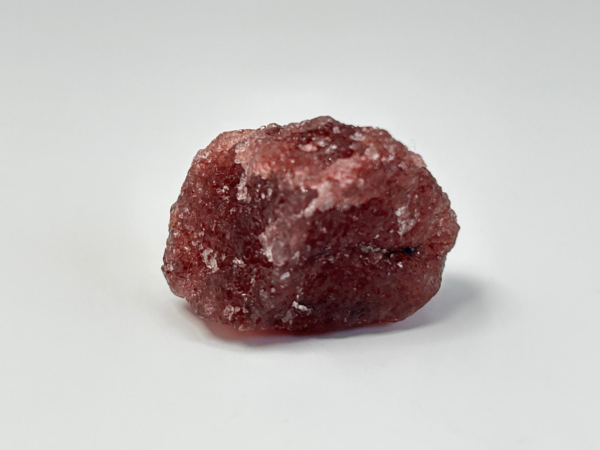Natural Cherry Tanzurine Chunk for energy healing on table with white background.