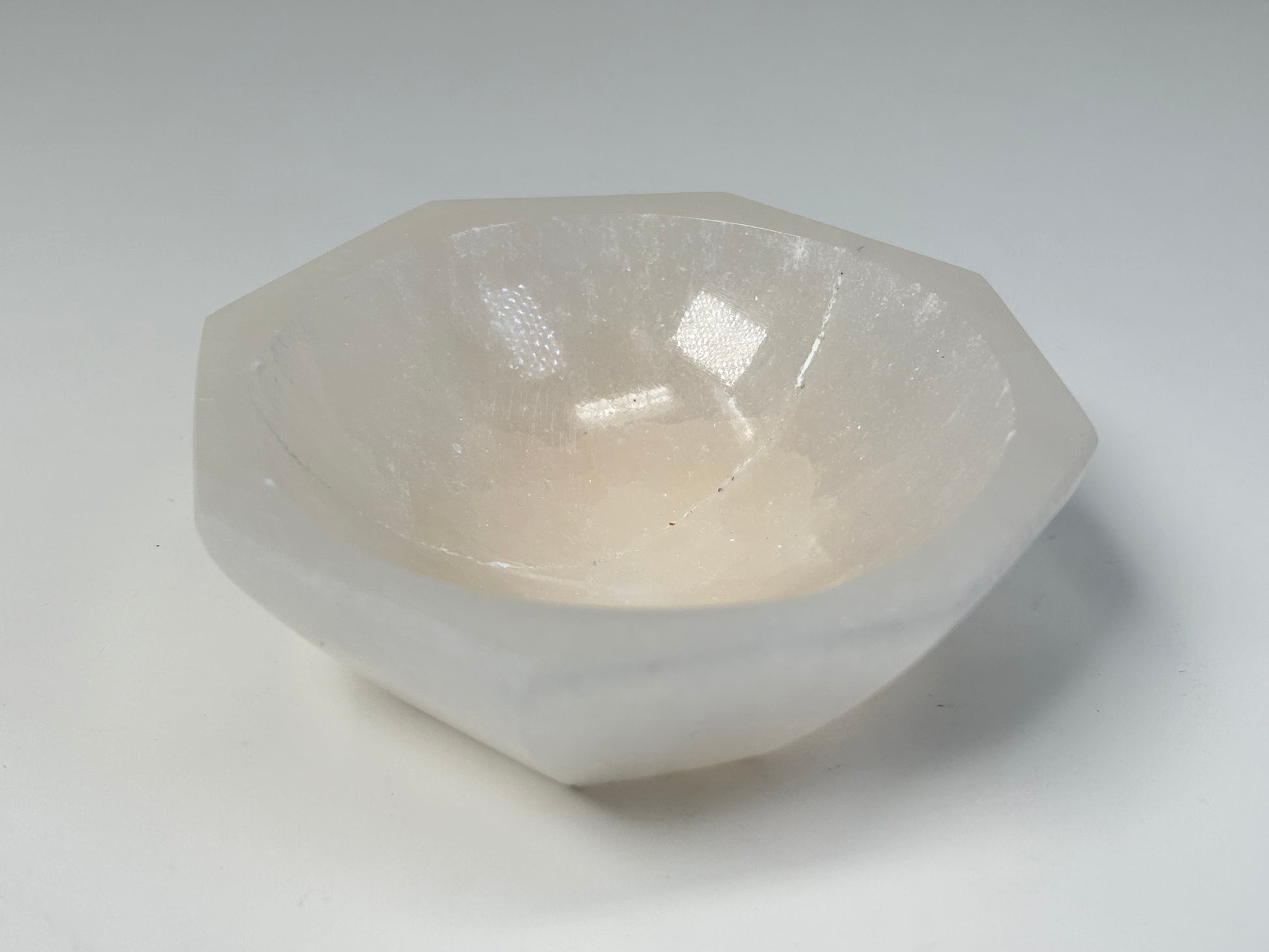 Octagon Selenite Bowl from Morocco for natural grounding on table with white background 