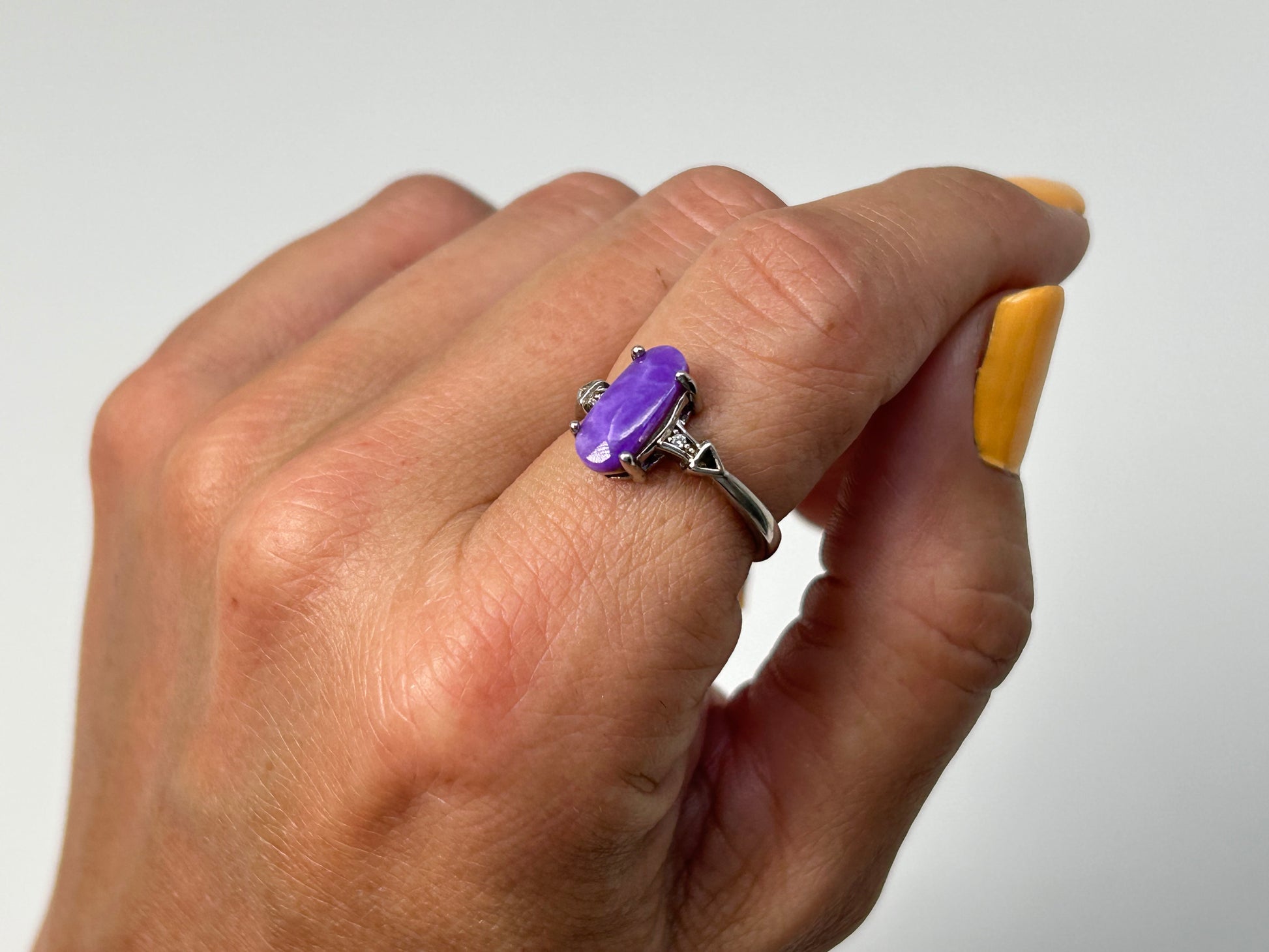 Close up of a Purple Sugilite Crystal in Sterling Silver Ring with Cubic Zirconia for meditation and energy work with white background