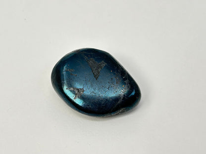 A polished dark blue Rare Healing Covellite Stone with a metallic sheen and natural inclusions, photographed on a plain light background.
