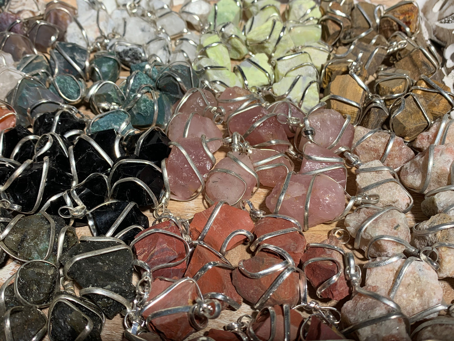 Raw Crystal Pendants That Call to You for meditation and energy work displayed on table
