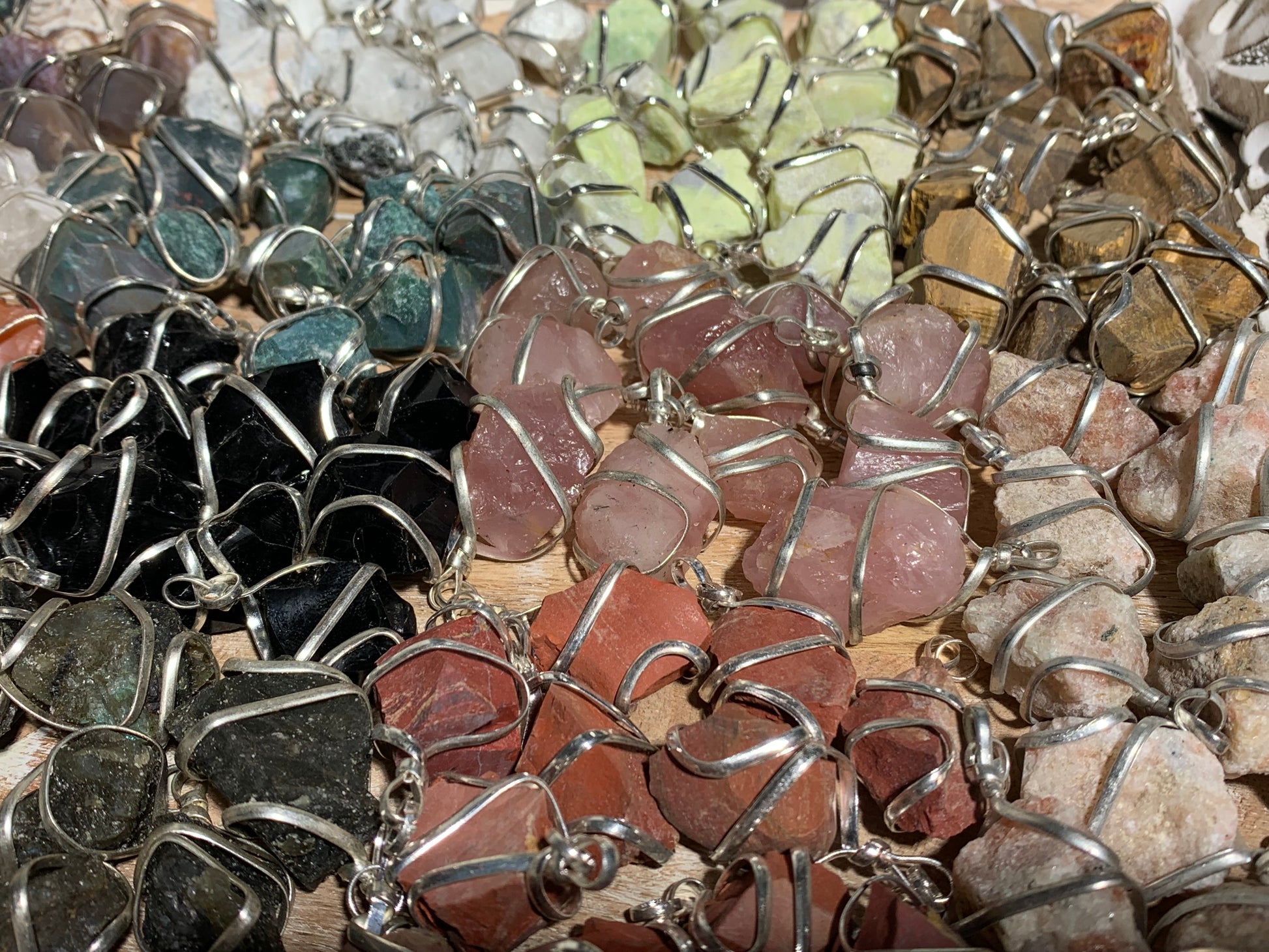 Raw Crystal Pendants That Call to You for meditation and energy work displayed on table