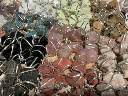 Raw Crystal Pendants That Call to You for meditation and energy work displayed on table