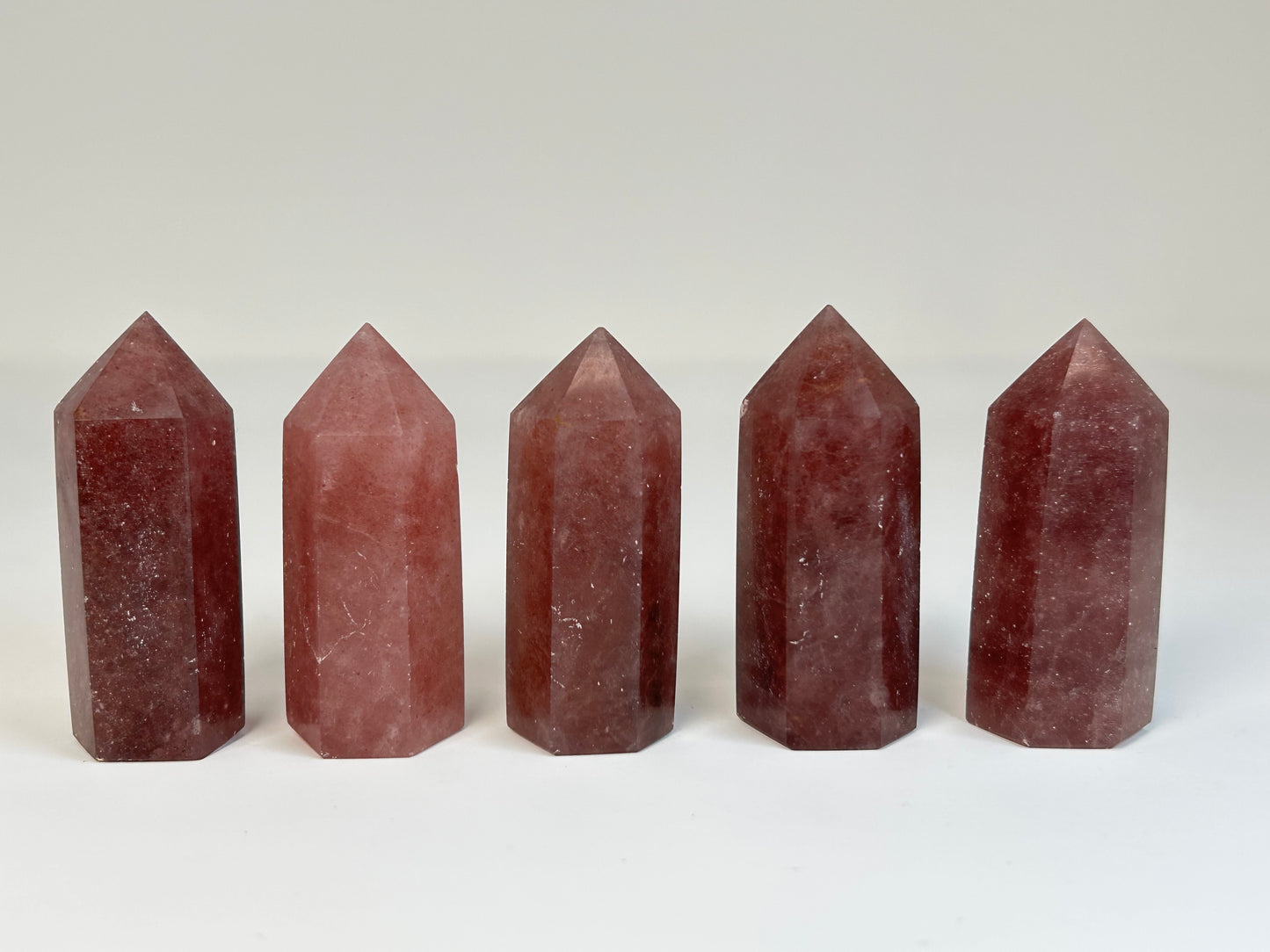 Five Red Aventurine Crystal Towers for reiki charged natural crystal healing on a white background