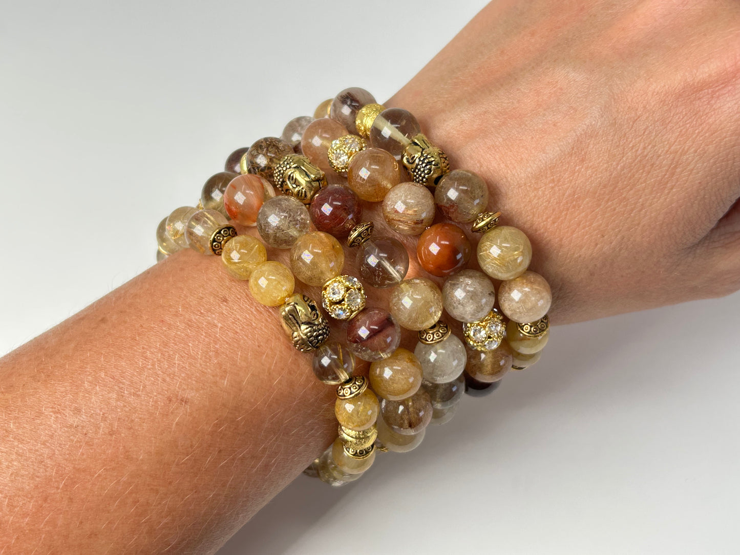 Wrist wearing Rutile Quartz Bracelets for natural grounding with white background