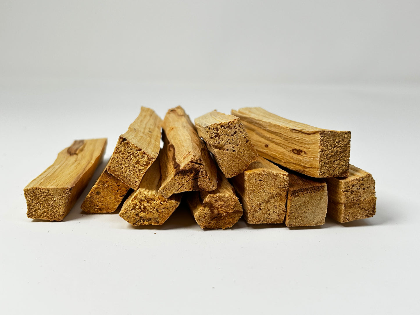 Sacred Wood Palo Santo Sticks on table top with white background