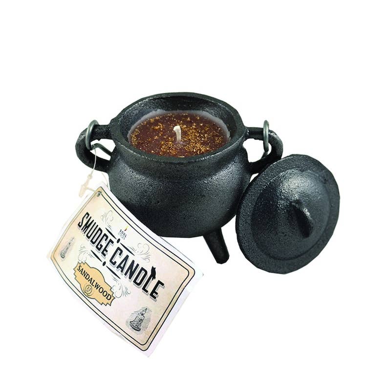 Black cast iron cauldron with a candle labeled 'Smudge Candle' on a white background