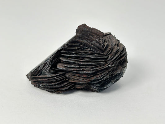 A Specularite Cluster for natural grounding crystal healing stone with white gray floral background