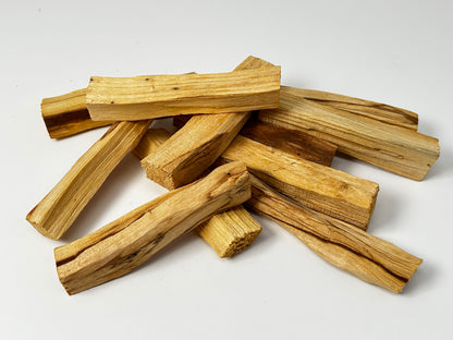 Stack of  Palo Santo Sticks for Energetic Renewal used to gently cleanse, reset, and uplift the energy of your aura and environment on a white background