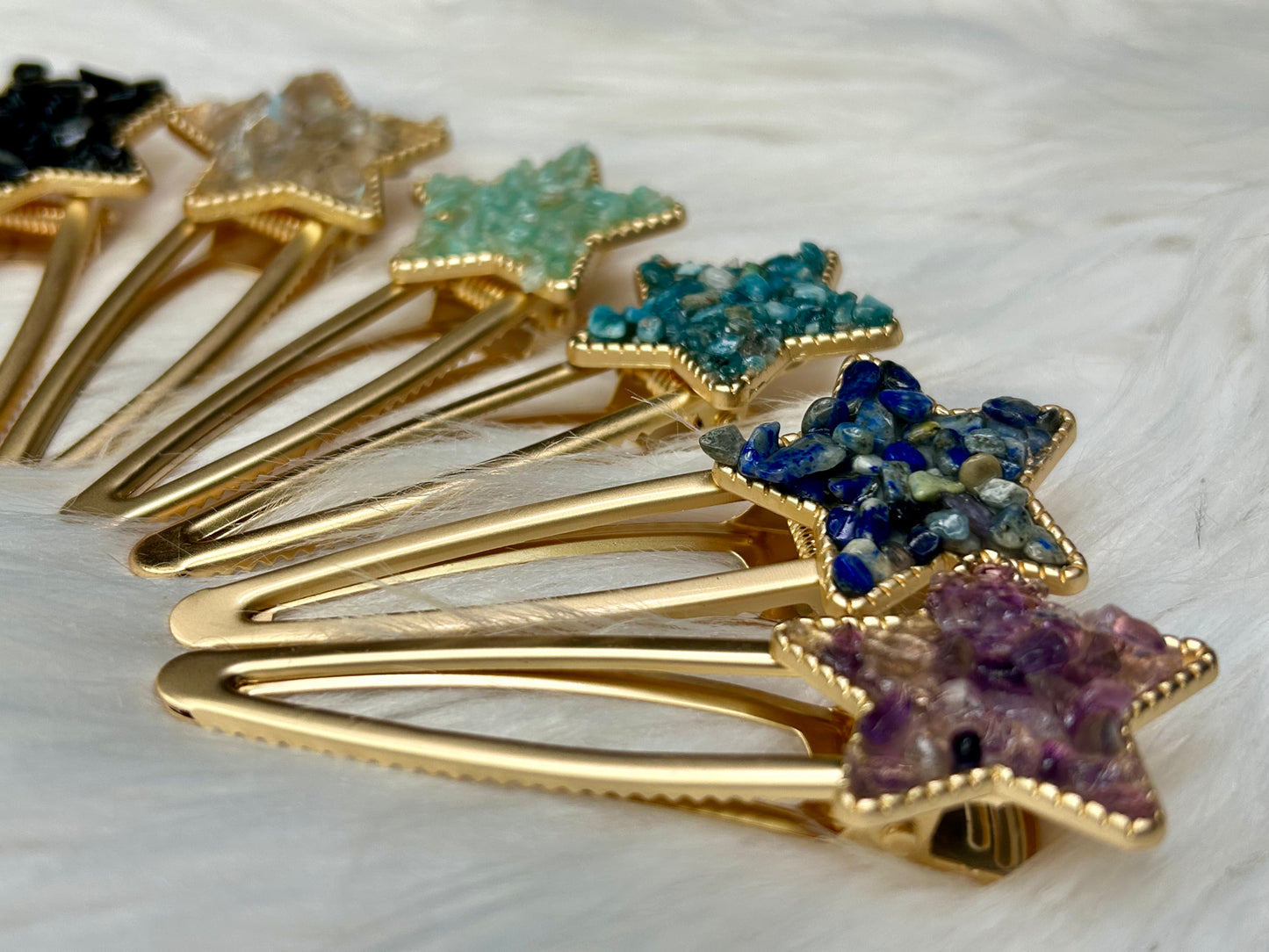 Gold hair clips with star-shaped gemstones on a white background symbolizing guidance, clarity, and inner light
