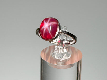 Star Ruby Ring in Sterling Silver on table stand with gray background.