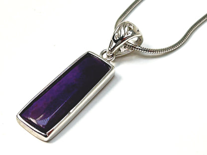 Sugilite Sterling Silver Pendant for natural grounding on table with white background 