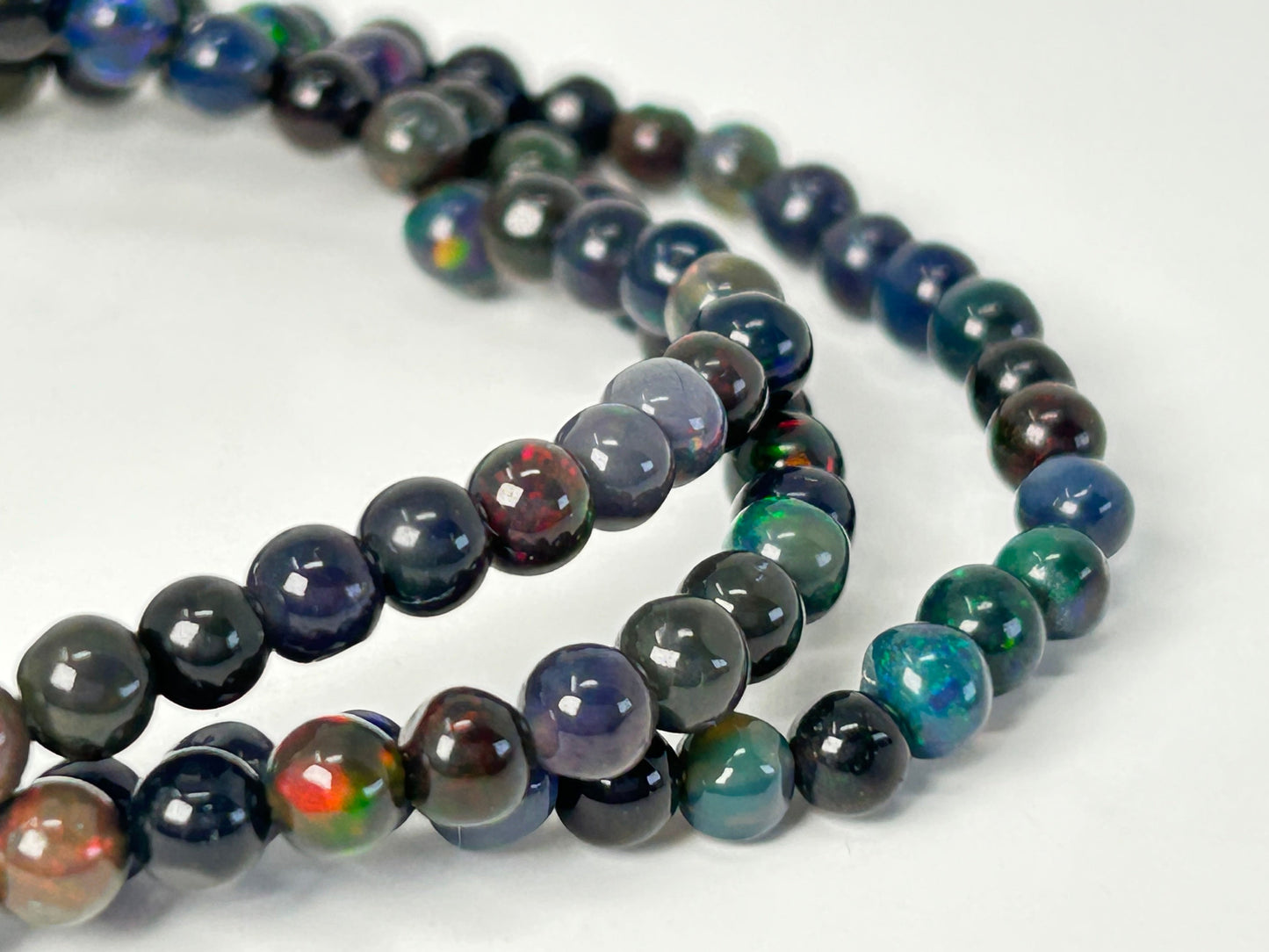 Multicolored Transformative Black Opal Bracelets on a white background