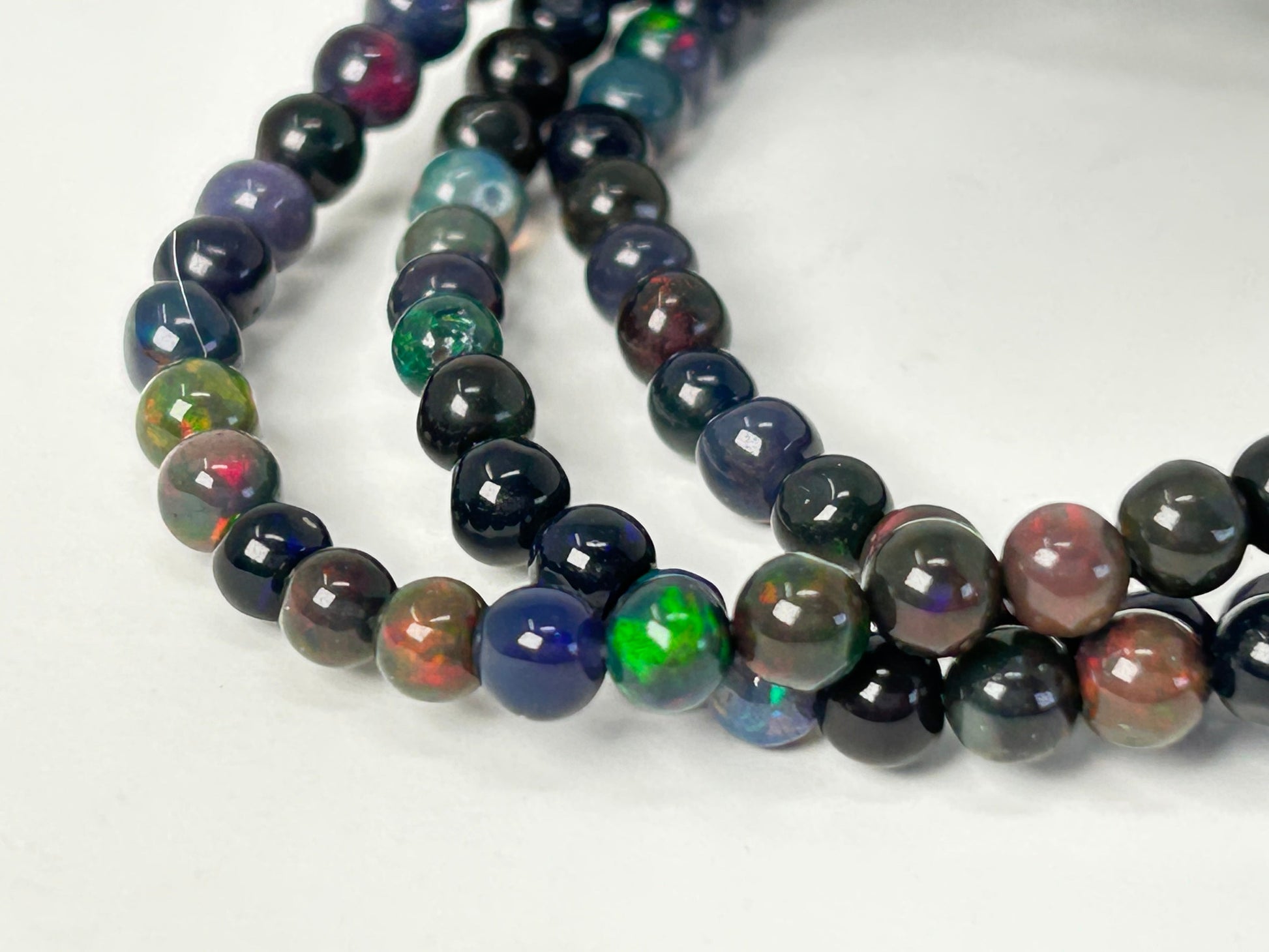 Close up of Transformative Black Opal Bracelets on a white background
