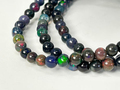Close up of Transformative Black Opal Bracelets on a white background
