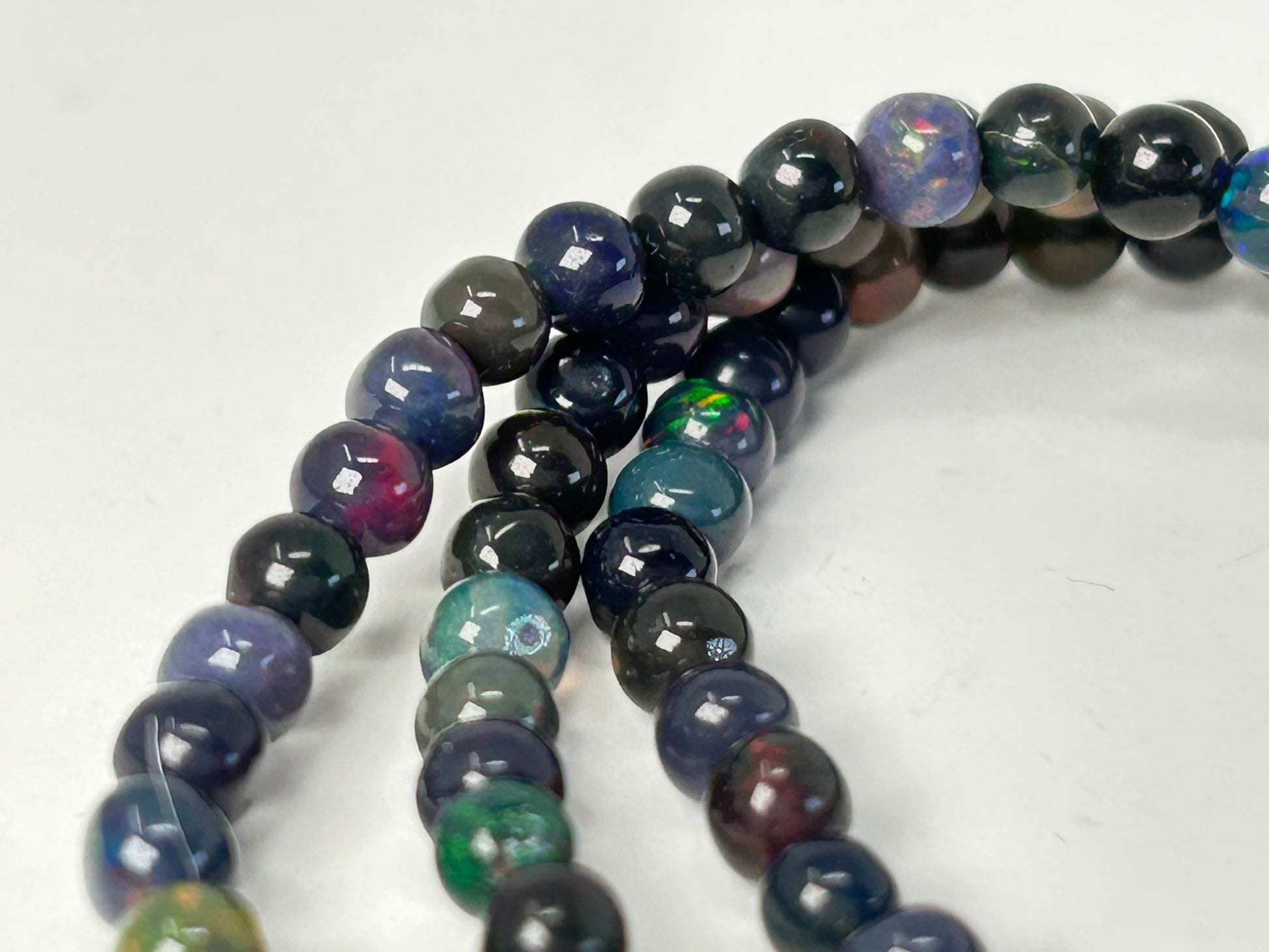 Multicolored Transformative Black Opal Bracelets on a white background