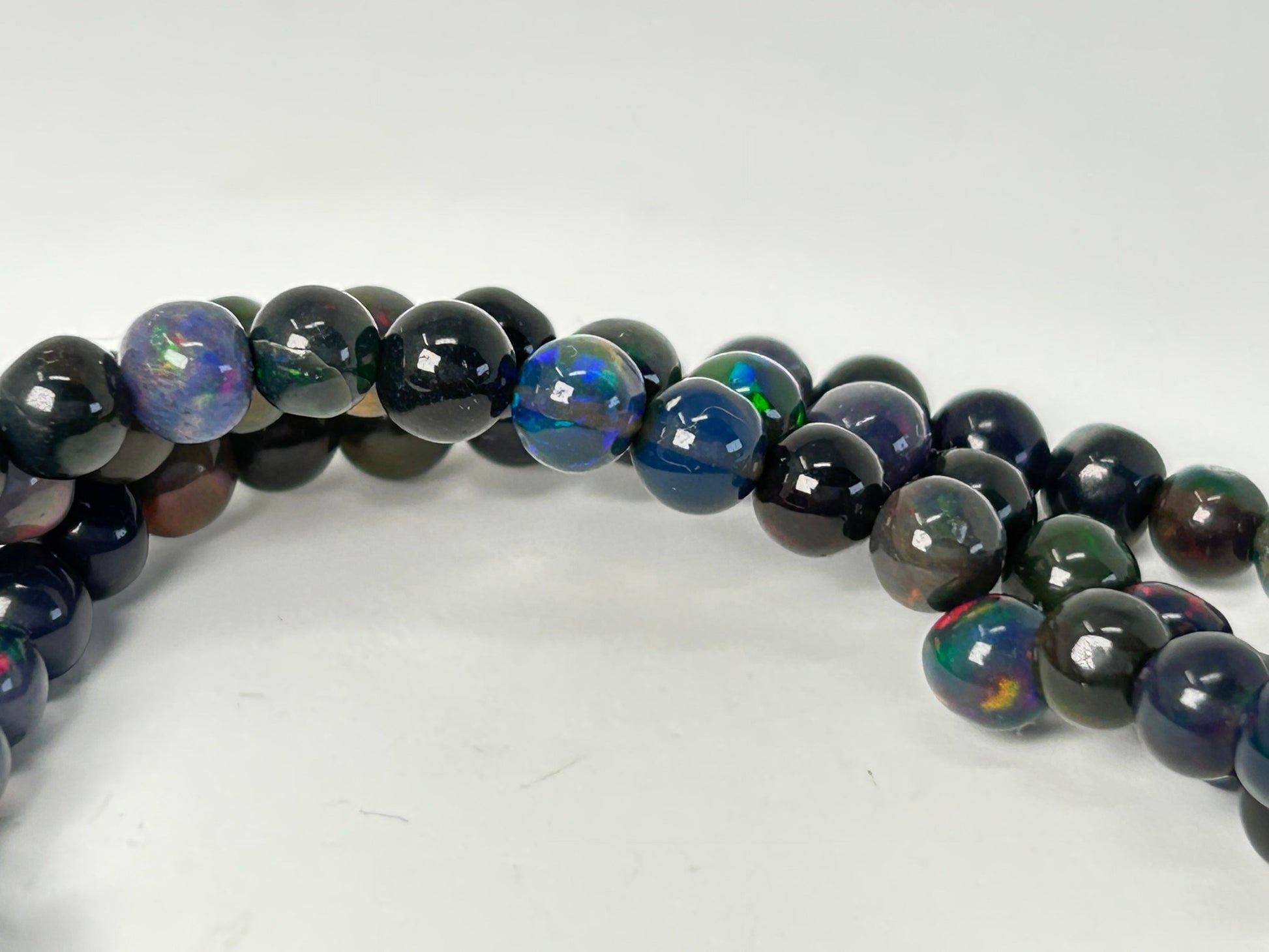 Multicolored Transformative Black Opal Bracelets on a white background