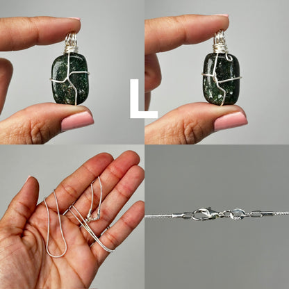 Hands holding Wire Wrapped Crystal Pendants and a silver necklace with white background.