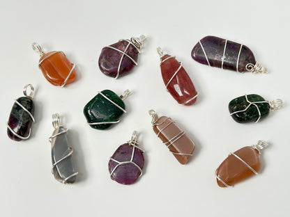 Collection of various Wire Wrapped Crystal Pendants for natural grounding on a white background