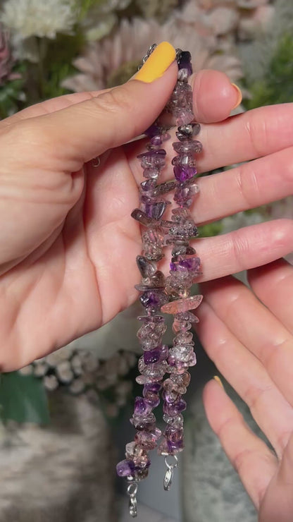 Hands holding a multi-colored Super 7 Chip Bead Bracelet for meditation and energy work with white background